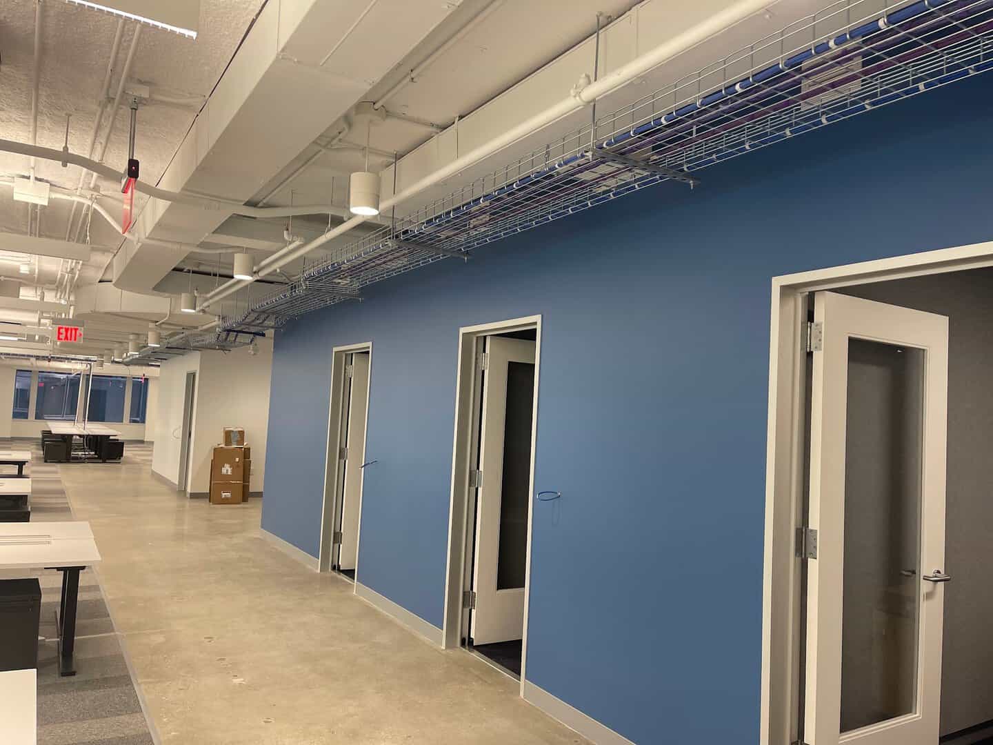 Interior commercial painting: office corridor with blue accent wall