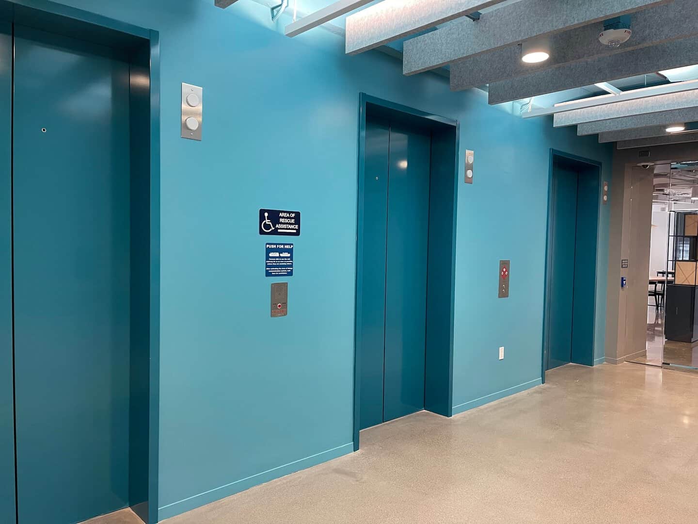 Interior commercial painting: elevator lobby painted teal