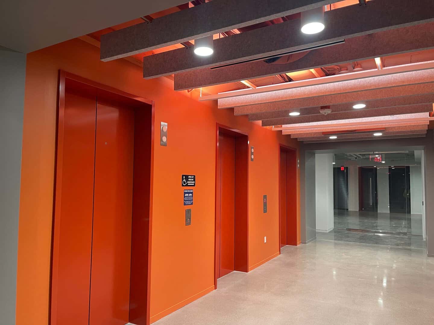 Interior commercial painting: elevator lobby painted orange