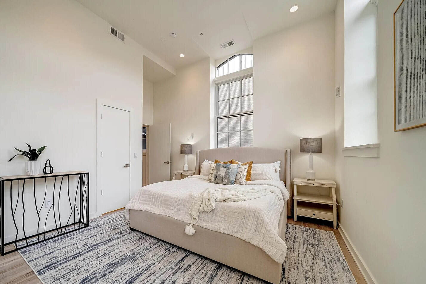 Interior house painting: painted bedroom with tall windows