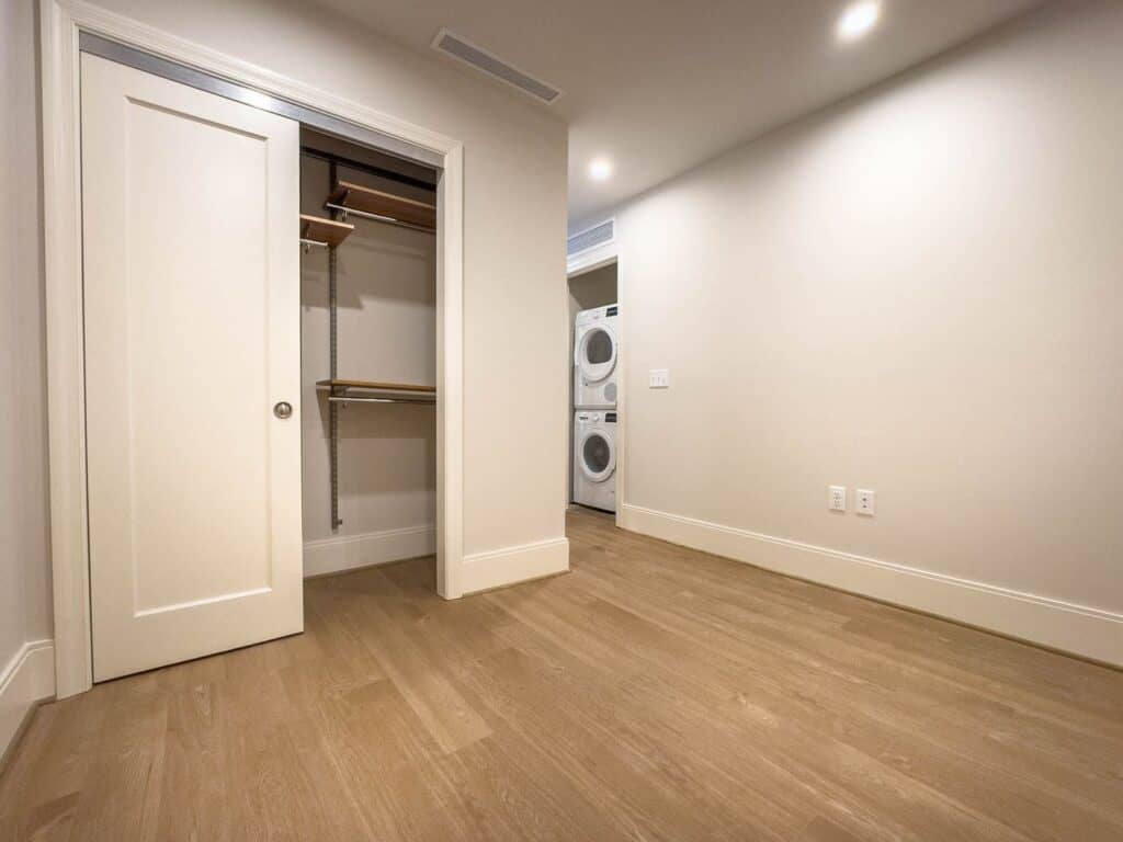 Painted bedroom with closet and hardwood floors